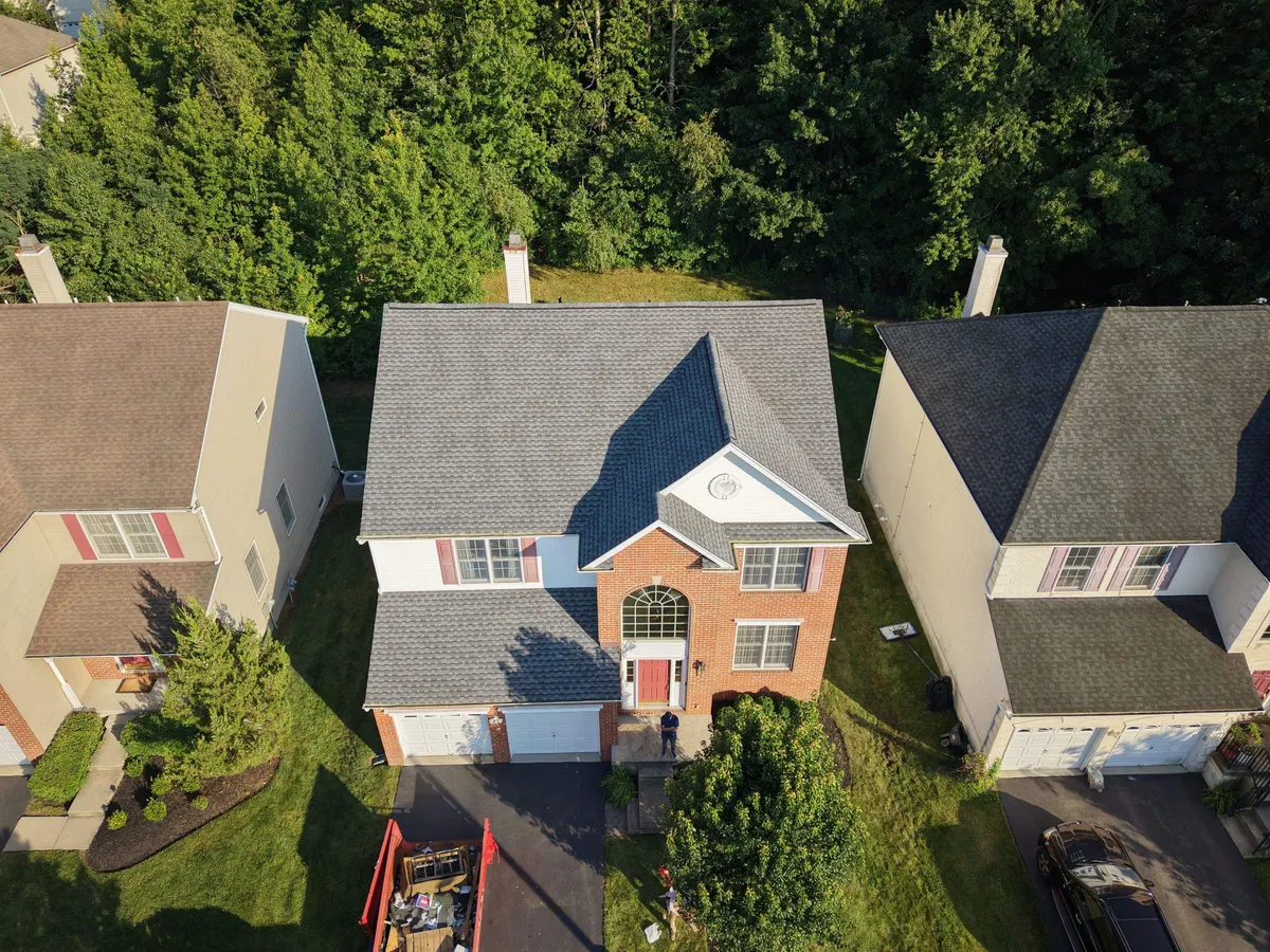 Drone view of a new roof on a brick-front colonial on Lockwood Drive in Princeton, NJ, by Pujols Roofing.
