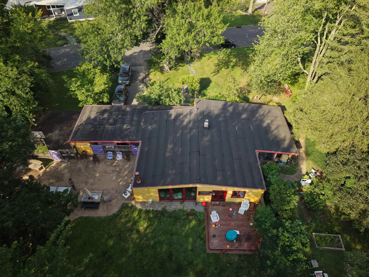 Drone view of a new flat roof on a modern house in Princeton, NJ, by Pujols Roofing.