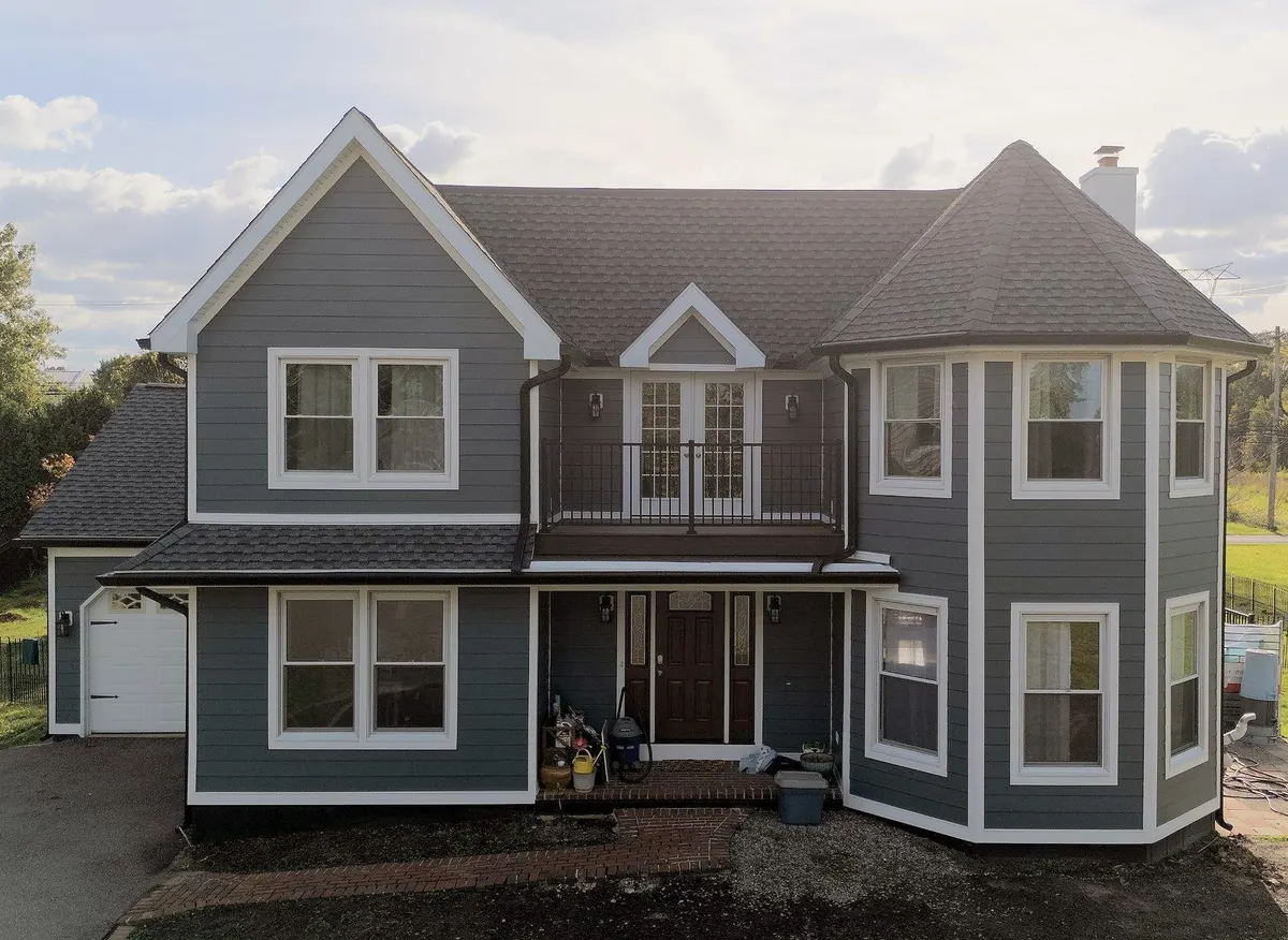 The same Jamison, PA house after a full exterior makeover with James Hardie siding in Evening Blue, a GAF Ultra HDZ roof and a new rooftop deck, by Pujols Roofing.