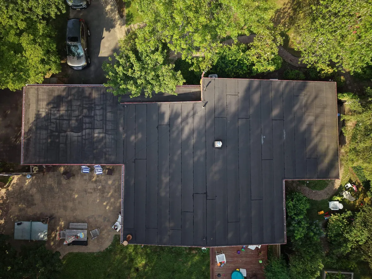 Drone view straight down on the new flat roof of a house on Deer Path in Princeton, NJ, by Pujols Roofing.