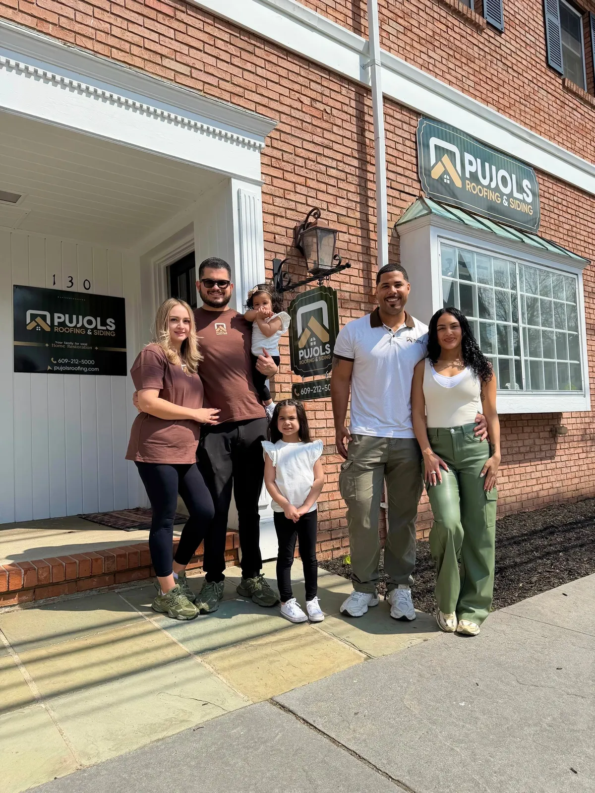 The Pujols family outside the Pujols Roofing & Siding office at 130 Washington St in Rocky Hill, NJ.
