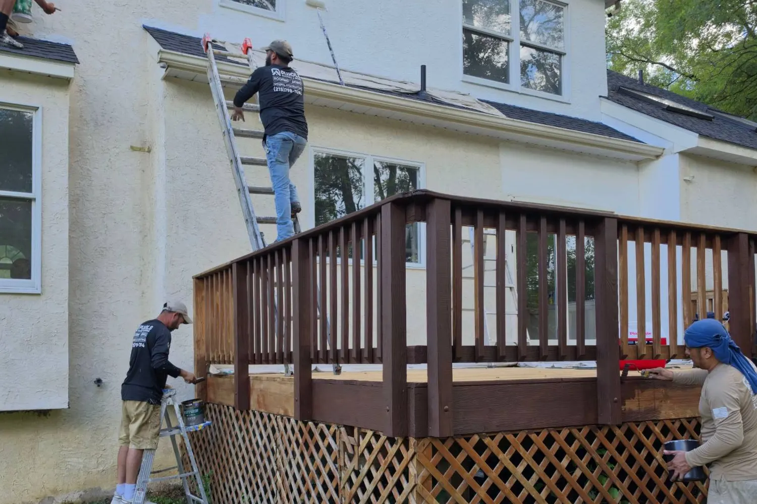 Exterior painting in progress on a Victorian historic home in Rocky Hill, NJ: fresh white Sherwin-Williams paint next to old peeling yellow siding.