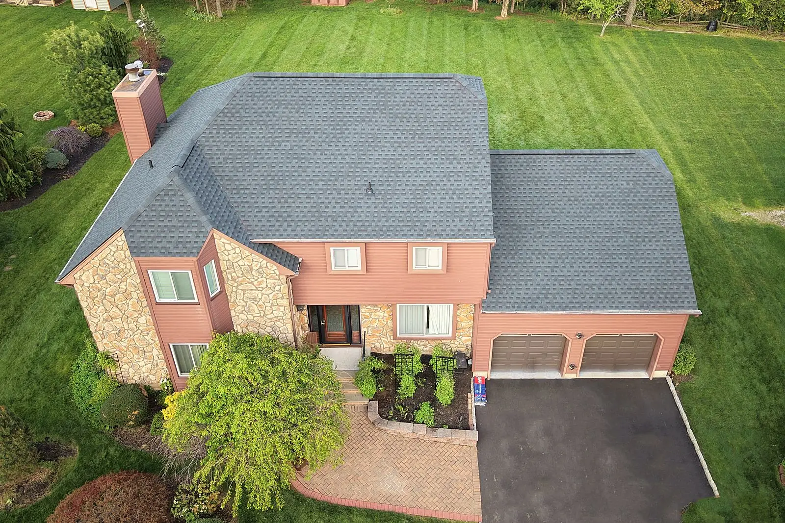 New GAF Timberline HDZ roof in Charcoal on a stone-and-brick colonial in Hillsborough, NJ, installed by Pujols Roofing & Siding LLC.